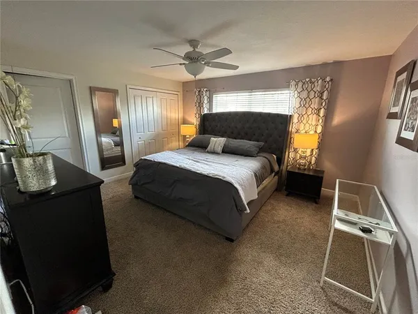 a spacious bedroom with a bed and dresser