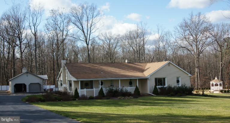 600 Mountain Road Fallston, MD 21047 - Photo 1 of 1 a front view of a house with a garden and trees