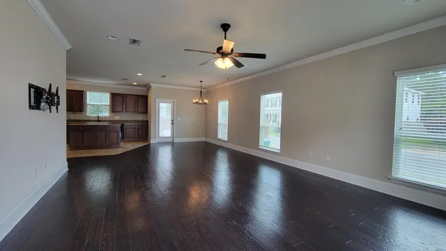 a view of a kitchen with a stove wooden cabinets and a kitchen view