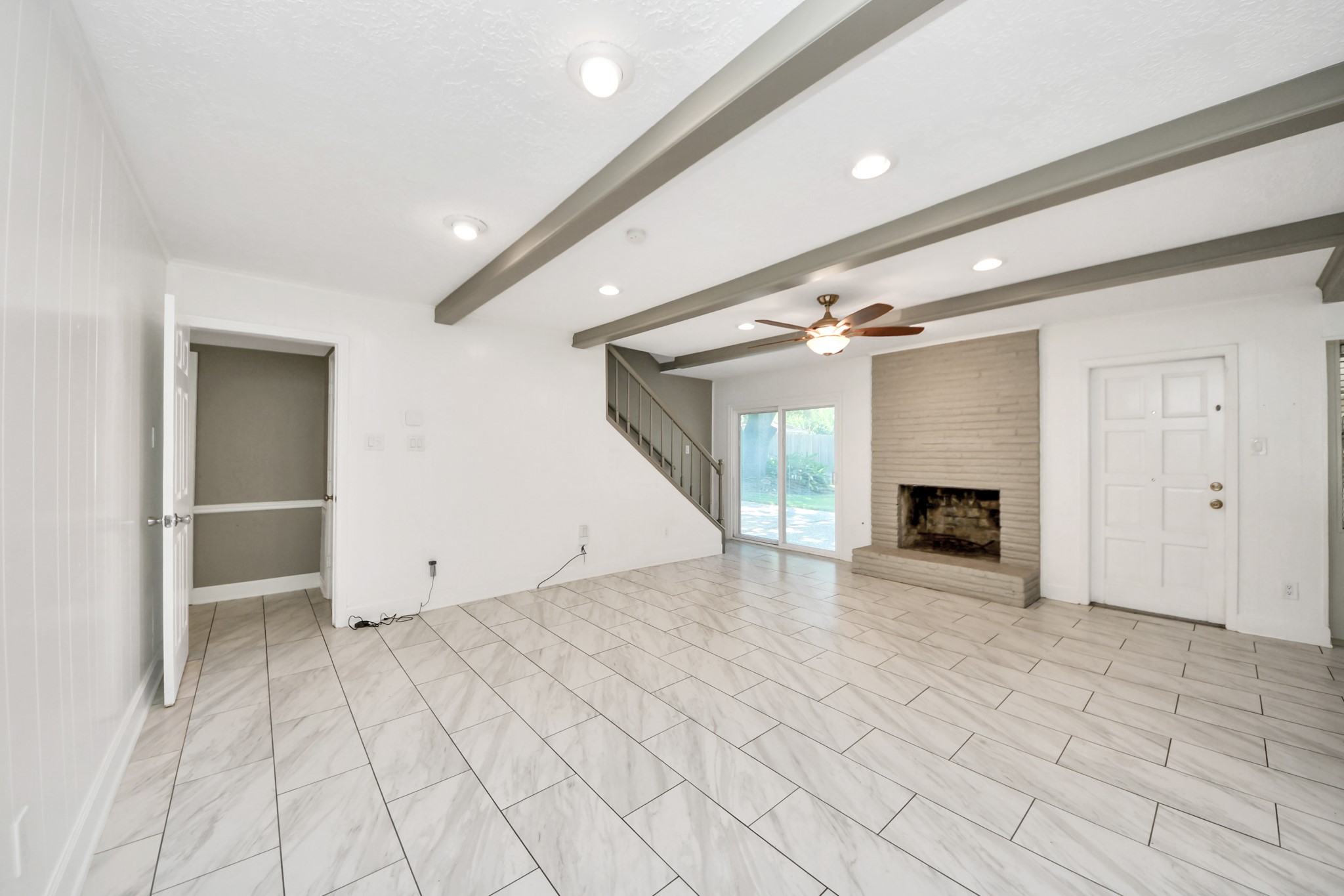 8119 Concho Street Houston, TX 77036 - Photo 12 of 35 With a fireplace in the living room, this is sure to bring together friends and family!