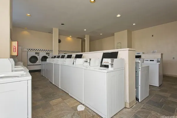 a view of a kitchen with refrigerator and white stove top oven