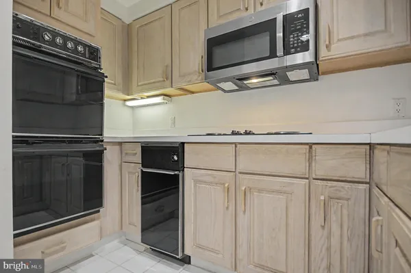 a living room with furniture a bookshelf and a large window