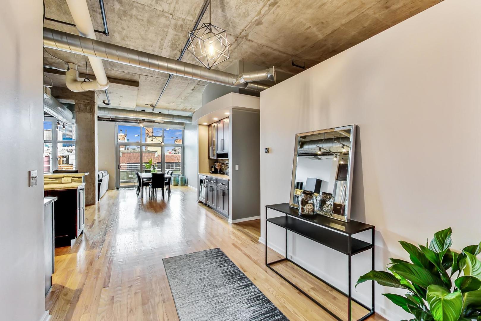 933 West Van Buren Street, Unit 903 Chicago, IL 60607 - Photo 2 of 50 a lobby with furniture and wooden floor