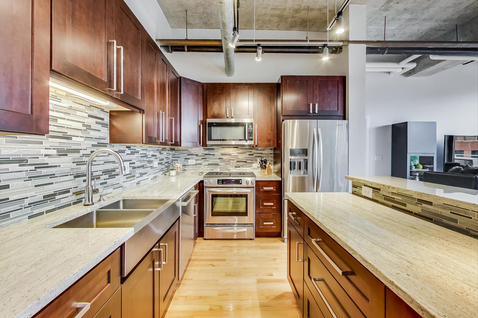 933 West Van Buren Street, Unit 903 Chicago, IL 60607 - Photo 18 of 50 a kitchen with a stove sink and cabinets
