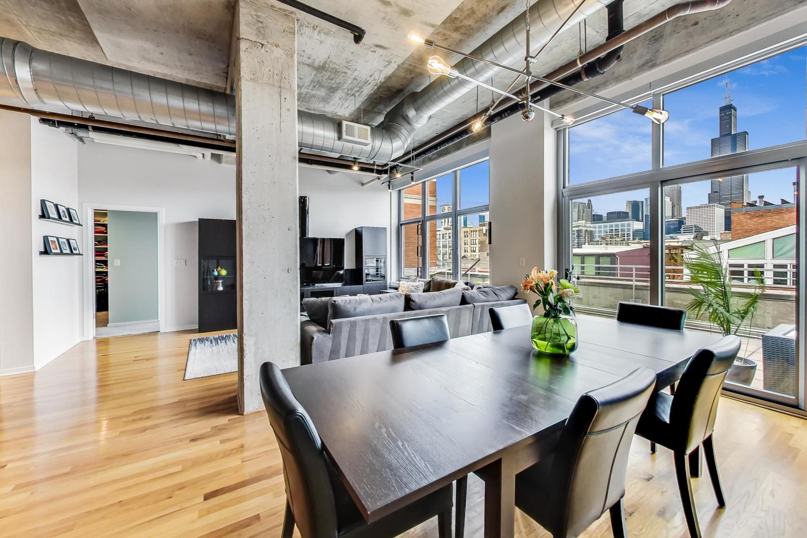 933 West Van Buren Street, Unit 903 Chicago, IL 60607 - Photo 3 of 50 a view of a dining room with furniture window and wooden floor