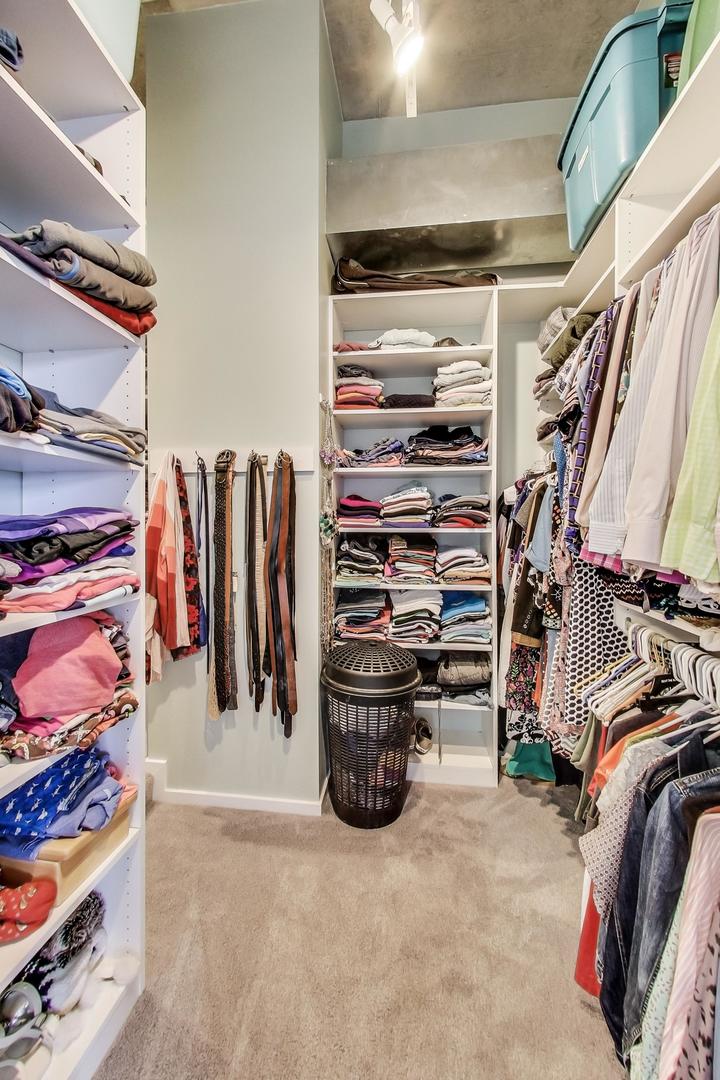 933 West Van Buren Street, Unit 903 Chicago, IL 60607 - Photo 25 of 50 a view of walk in closet with clothes and shoes