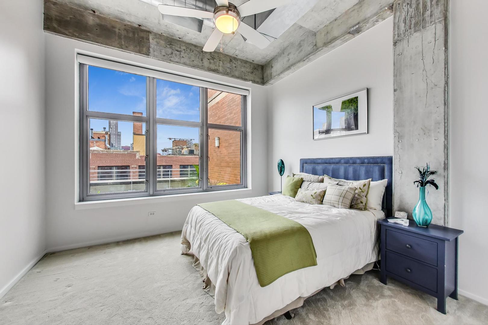 933 West Van Buren Street, Unit 903 Chicago, IL 60607 - Photo 29 of 50 a bedroom with a large bed and a window