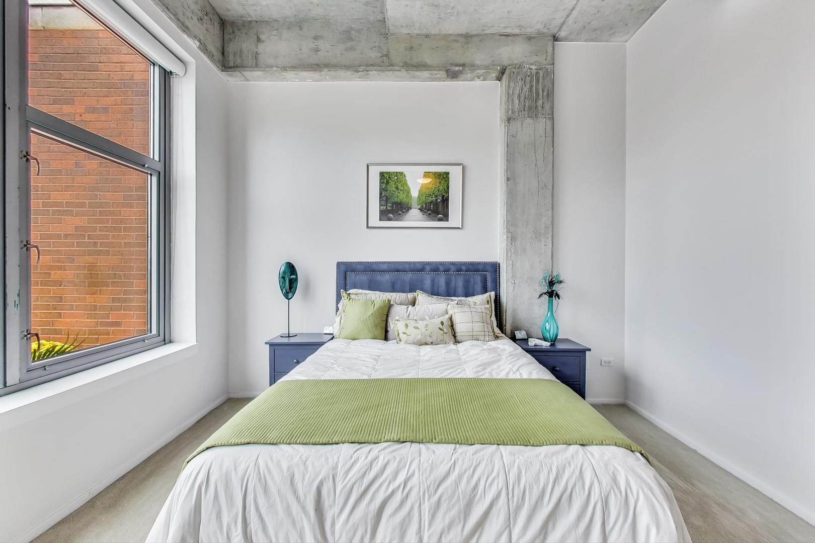 933 West Van Buren Street, Unit 903 Chicago, IL 60607 - Photo 31 of 50 a bed sitting in a bedroom next to a window