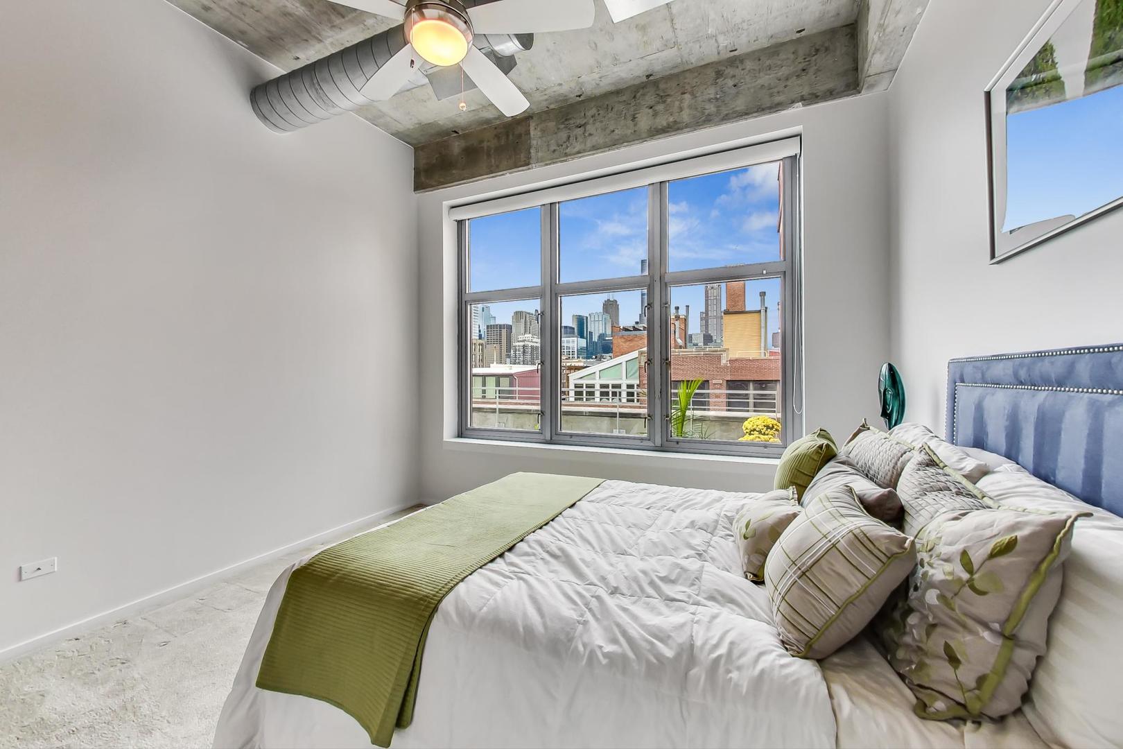 933 West Van Buren Street, Unit 903 Chicago, IL 60607 - Photo 32 of 50 a bedroom with a bed and a window