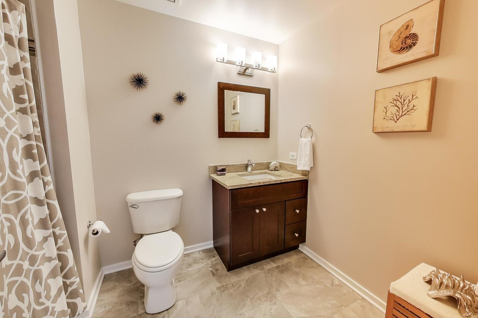 933 West Van Buren Street, Unit 903 Chicago, IL 60607 - Photo 33 of 50 a bathroom with a toilet sink and mirror