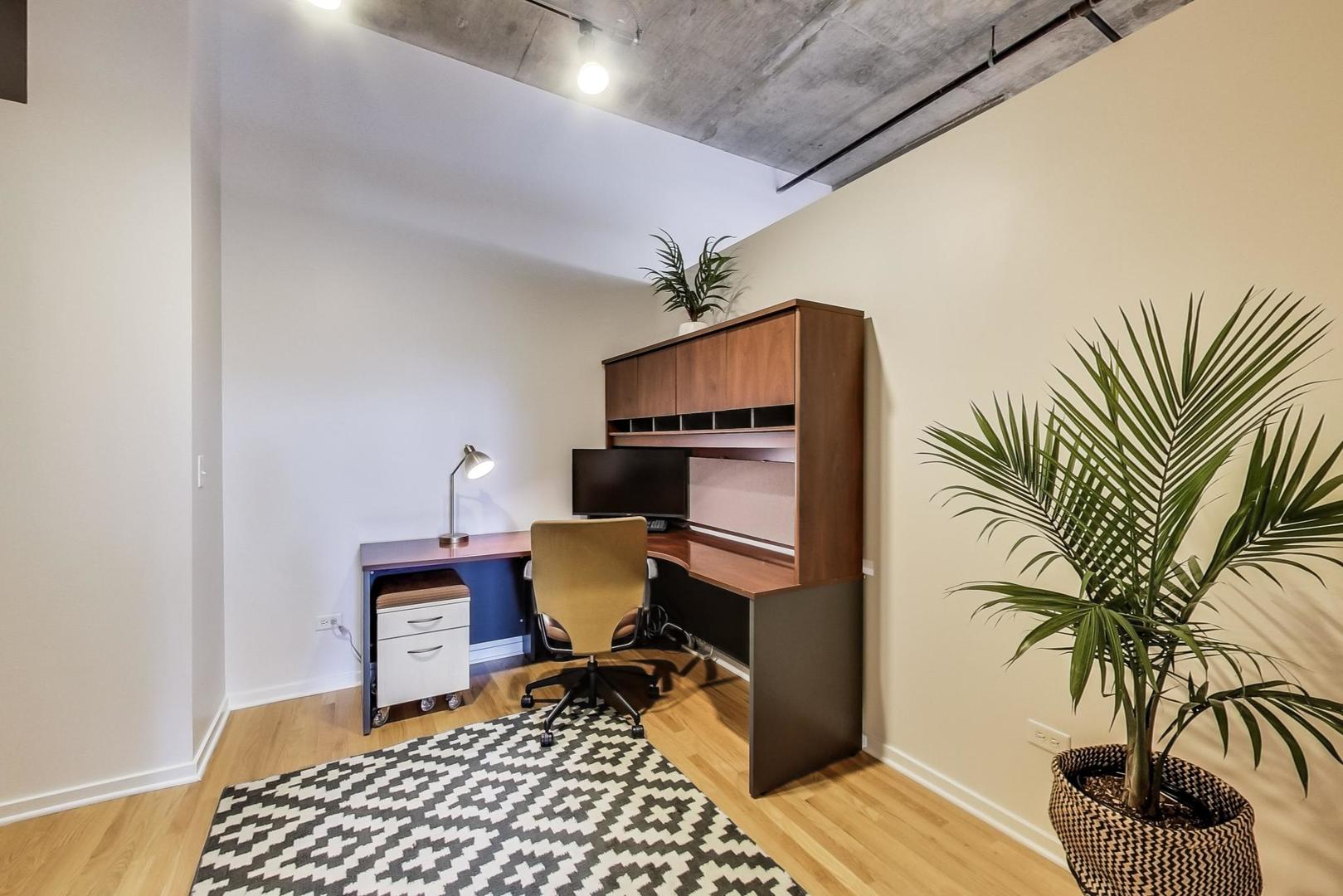 933 West Van Buren Street, Unit 903 Chicago, IL 60607 - Photo 34 of 50 a workspace with furniture and wooden floor
