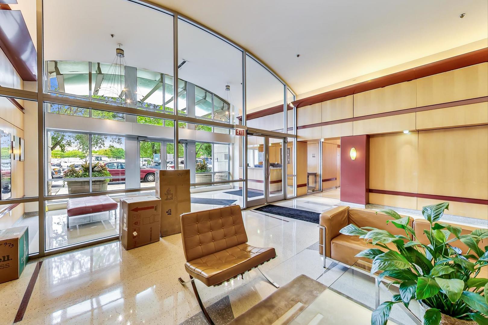 933 West Van Buren Street, Unit 903 Chicago, IL 60607 - Photo 48 of 50 a lobby with furniture and floor to ceiling window