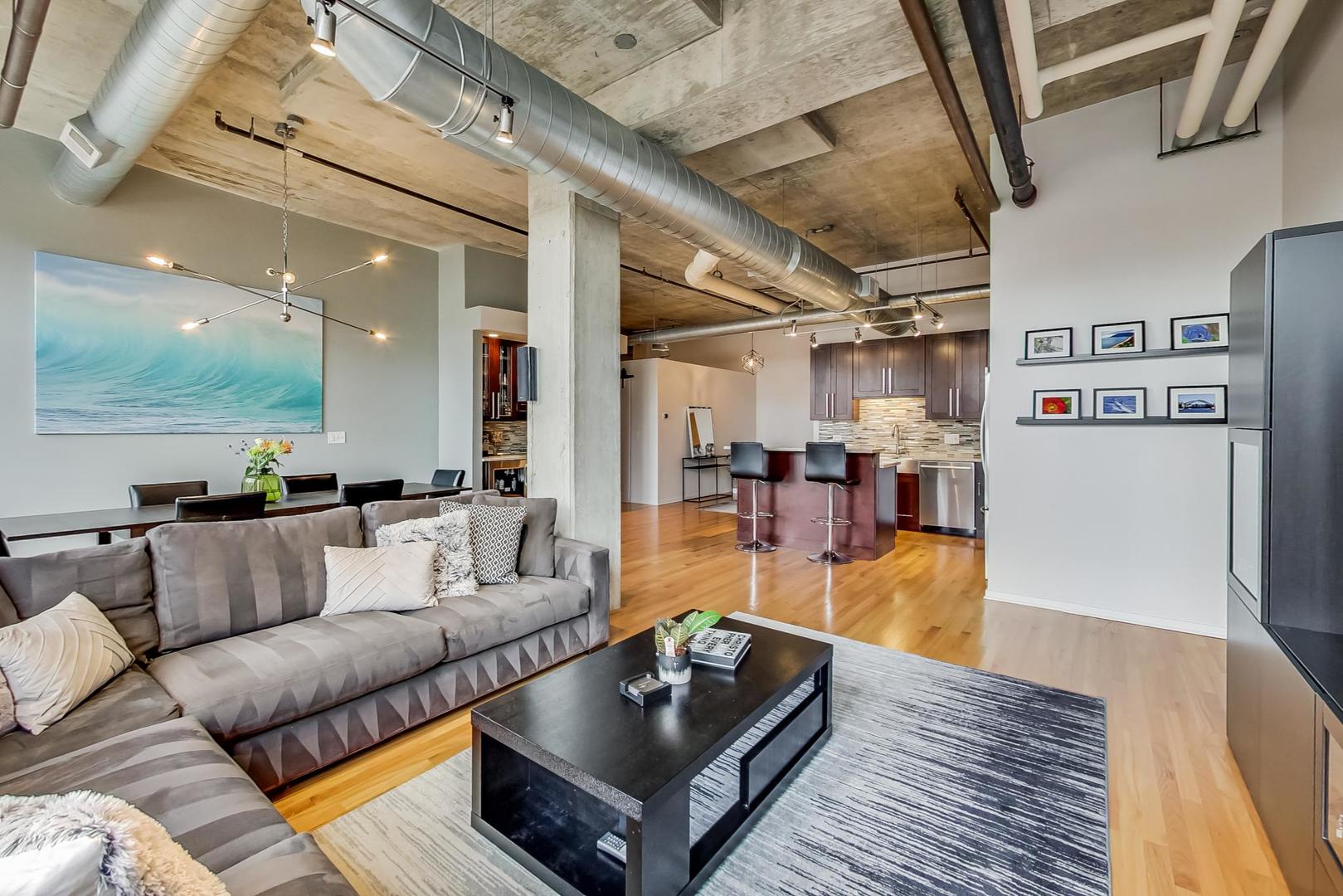 933 West Van Buren Street, Unit 903 Chicago, IL 60607 - Photo 7 of 50 a living room with furniture and a wooden floor