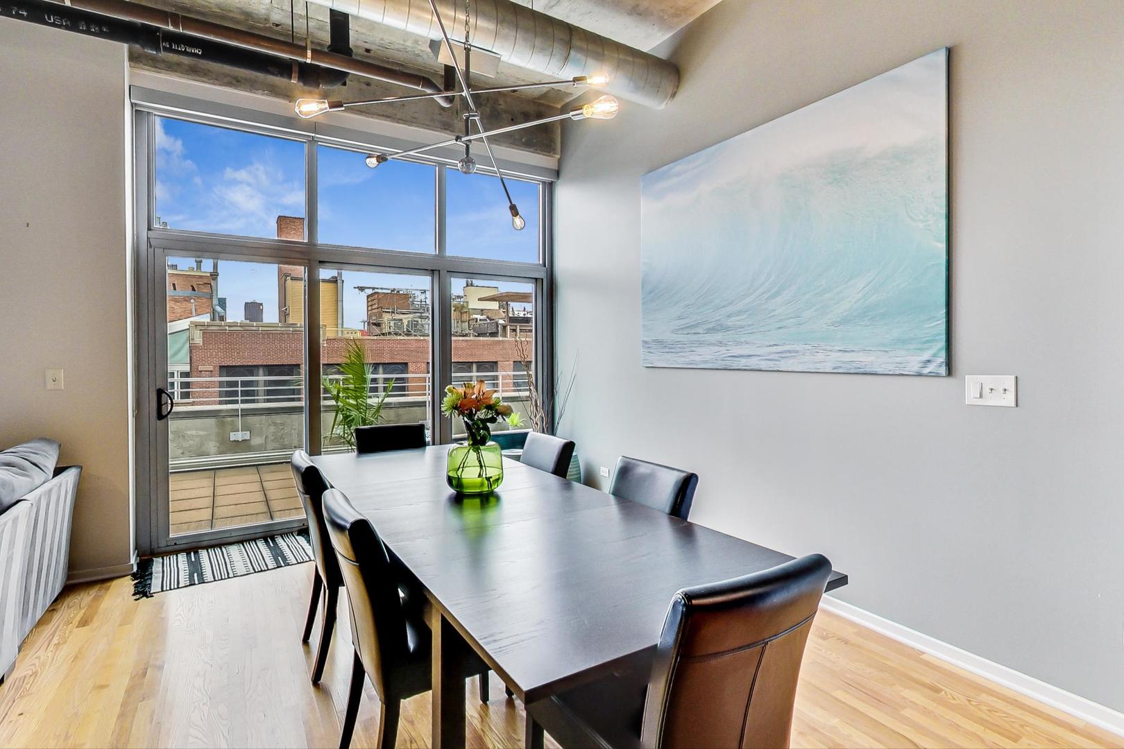933 West Van Buren Street, Unit 903 Chicago, IL 60607 - Photo 8 of 50 a view of a dining room with furniture window and outside view