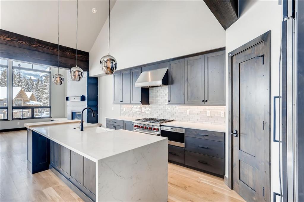 a kitchen with stainless steel appliances a sink stove and refrigerator
