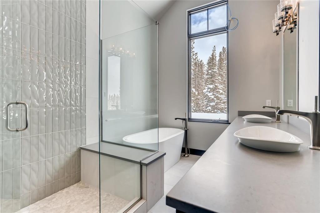 202 Cucumber Creek Road Breckenridge, CO 80424 - Photo 16 of 28 a bathroom with a double vanity sink window and a bathtub
