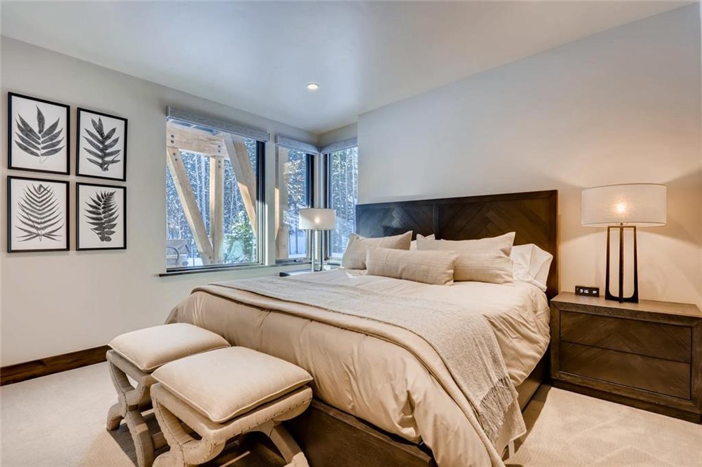202 Cucumber Creek Road Breckenridge, CO 80424 - Photo 17 of 28 a bedroom with a bed and wooden floor
