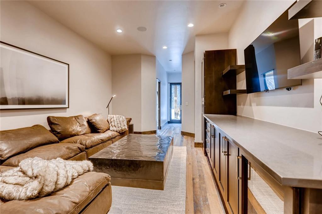 202 Cucumber Creek Road Breckenridge, CO 80424 - Photo 20 of 28 a living room with furniture and a flat screen tv