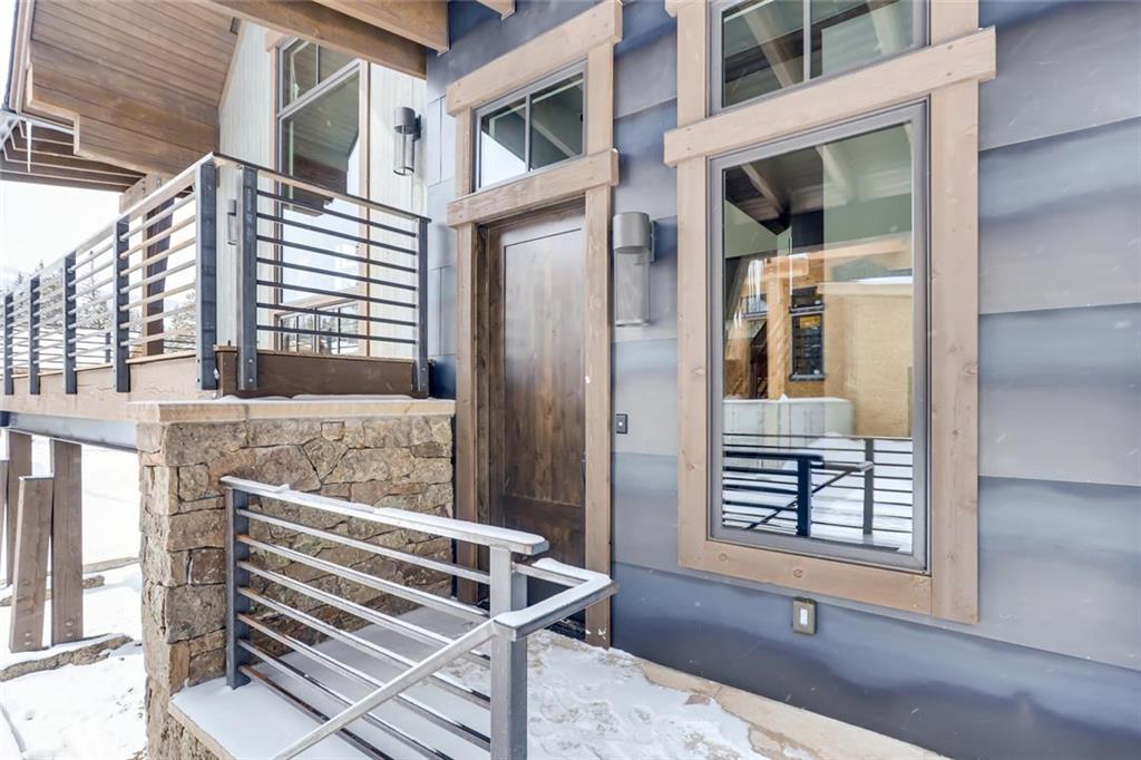 202 Cucumber Creek Road Breckenridge, CO 80424 - Photo 22 of 28 a view of house with a bench and floor to ceiling windows
