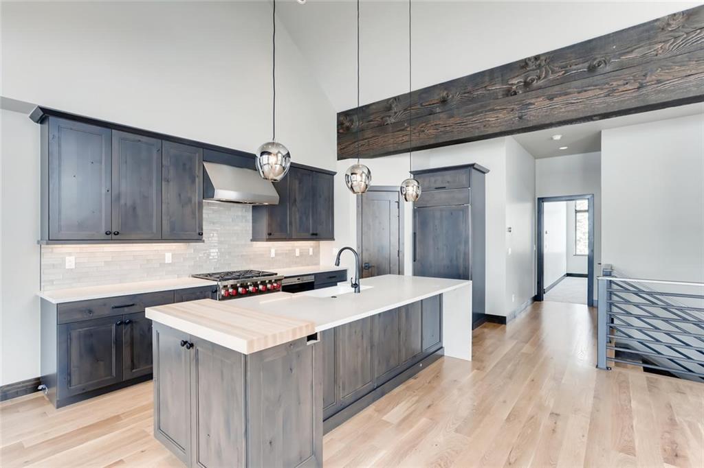 202 Cucumber Creek Road Breckenridge, CO 80424 - Photo 4 of 28 a kitchen with a stove a sink and cabinets