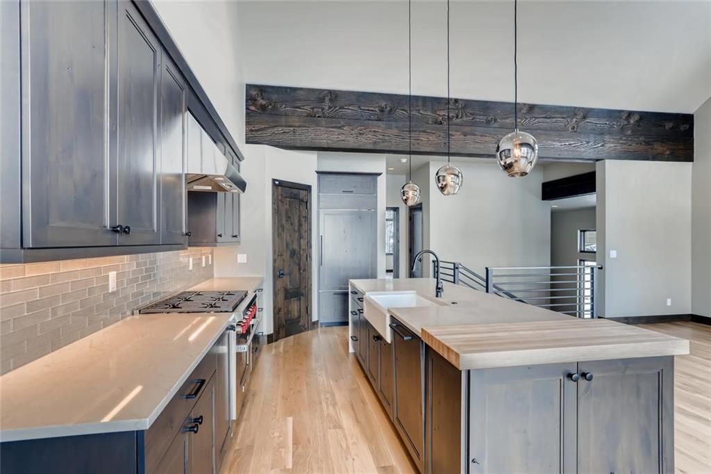 202 Cucumber Creek Road Breckenridge, CO 80424 - Photo 5 of 28 a kitchen with a sink stove and cabinets