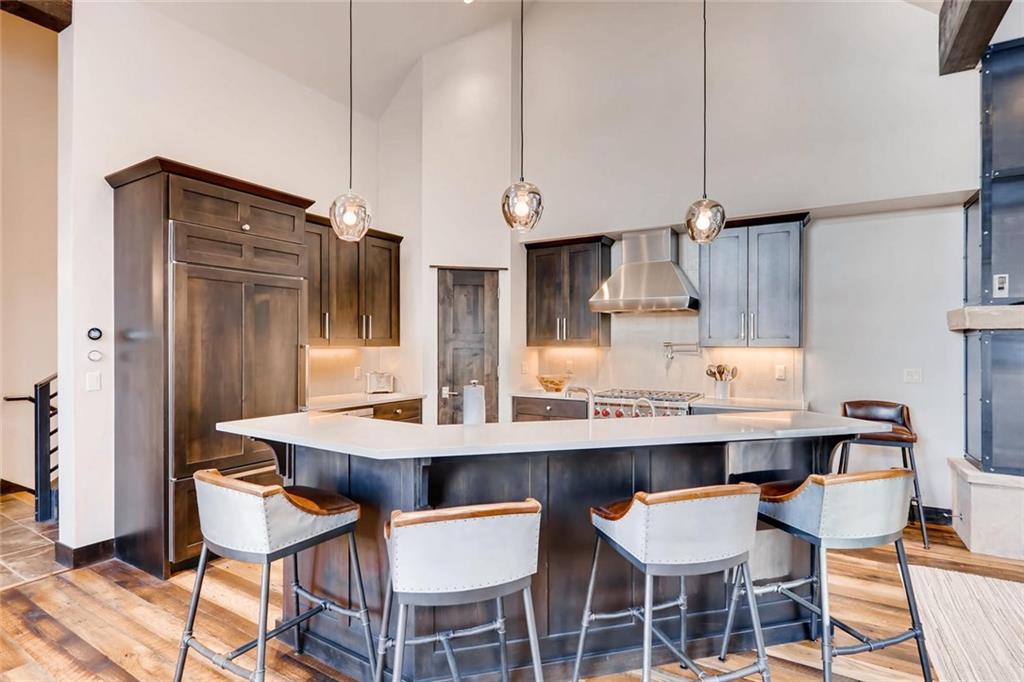202 Cucumber Creek Road Breckenridge, CO 80424 - Photo 6 of 28 a kitchen with stainless steel appliances a dining table and chairs