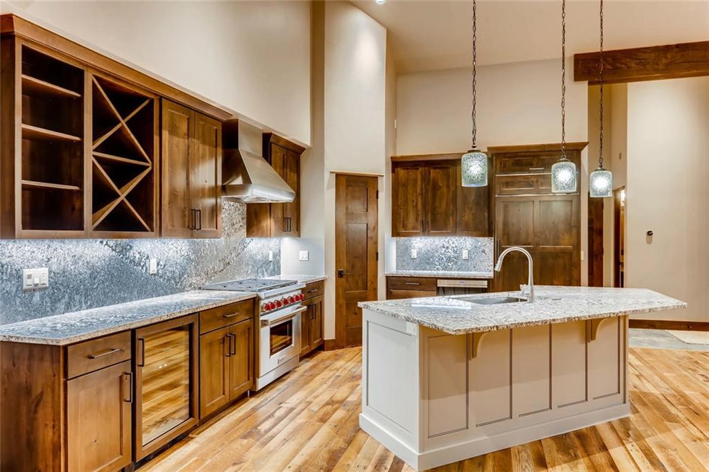 202 Cucumber Creek Road Breckenridge, CO 80424 - Photo 7 of 28 a kitchen with stainless steel appliances granite countertop a sink a stove and a wooden cabinets