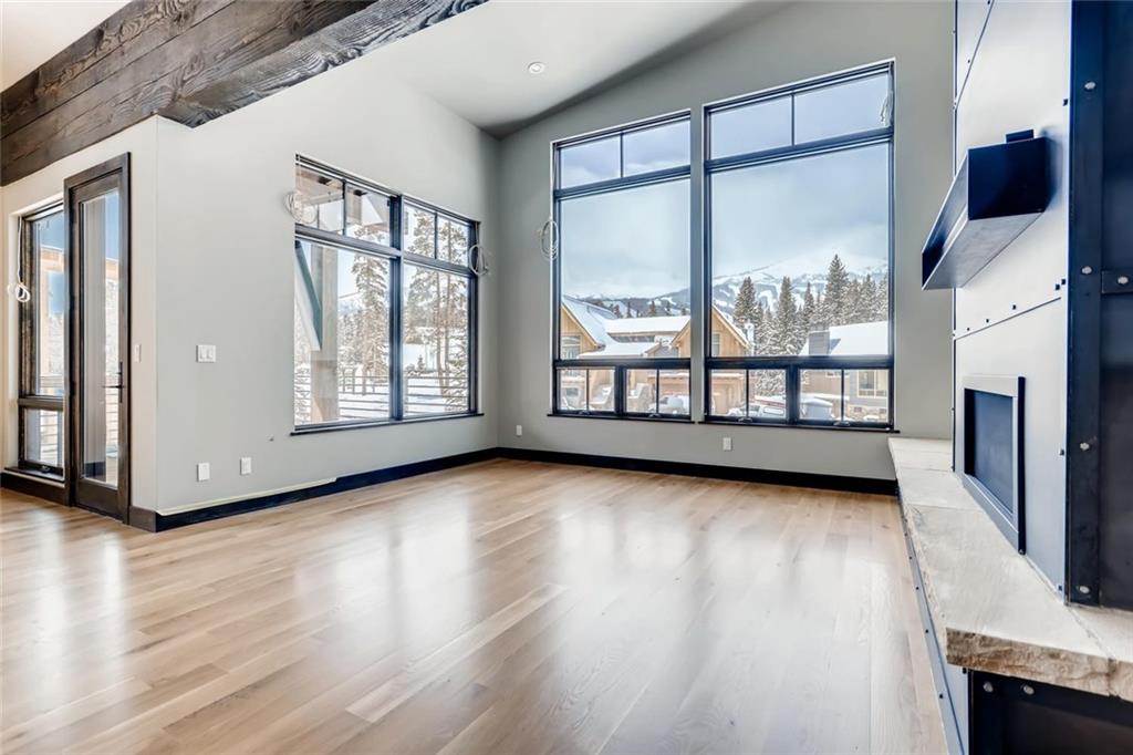 202 Cucumber Creek Road Breckenridge, CO 80424 - Photo 8 of 28 a view of an empty room with wooden floor and a window