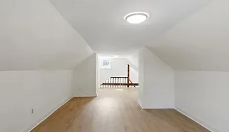 a view of a room with wooden floor