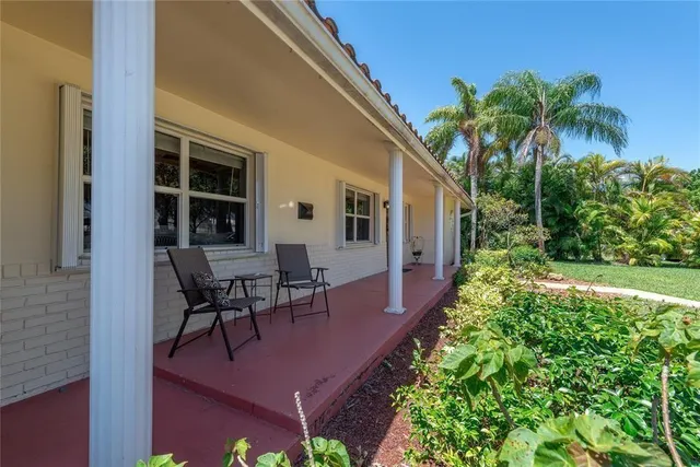 a view of a backyard with plants and a patio