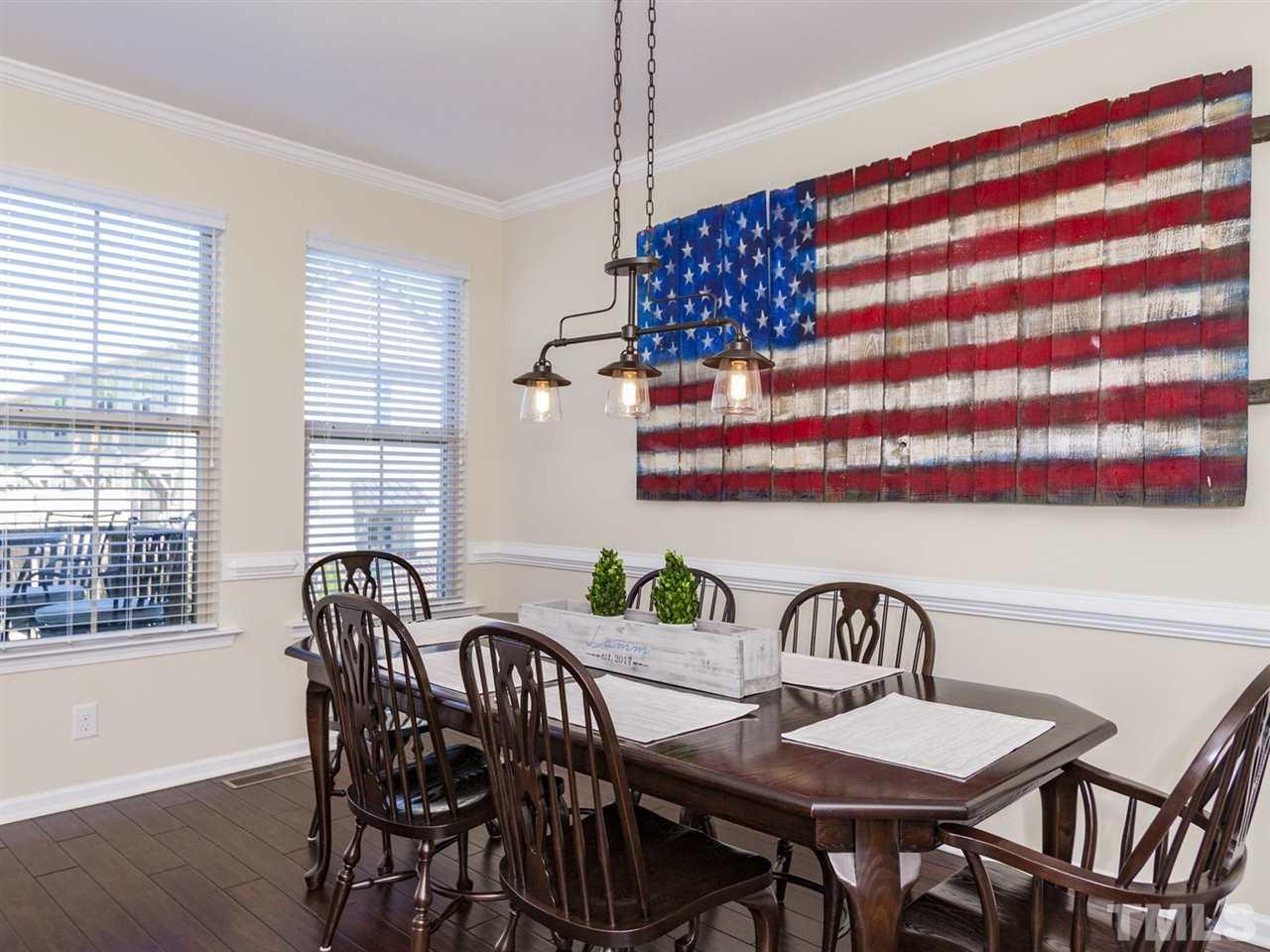 1310 Cornell Place Raleigh, NC 27607 - Photo 6 of 25 a view of a dining room and hall with table and chairs