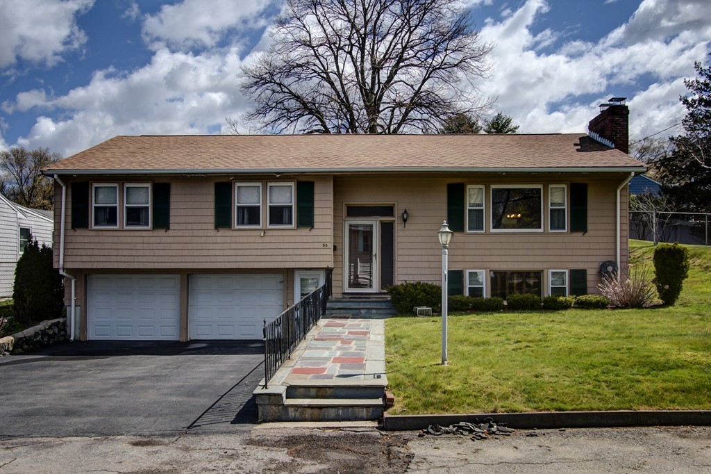 55 Tomahawk Road Arlington, MA 02474 - Photo 1 of 22 front view of a house with a yard