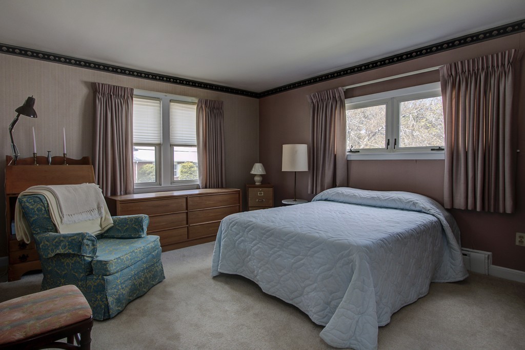 55 Tomahawk Road Arlington, MA 02474 - Photo 11 of 22 a bedroom with a bed couch and windows