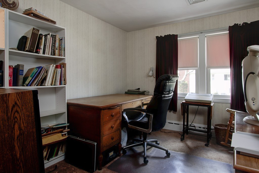 55 Tomahawk Road Arlington, MA 02474 - Photo 15 of 22 a view of a workspace with furniture and a bookshelf