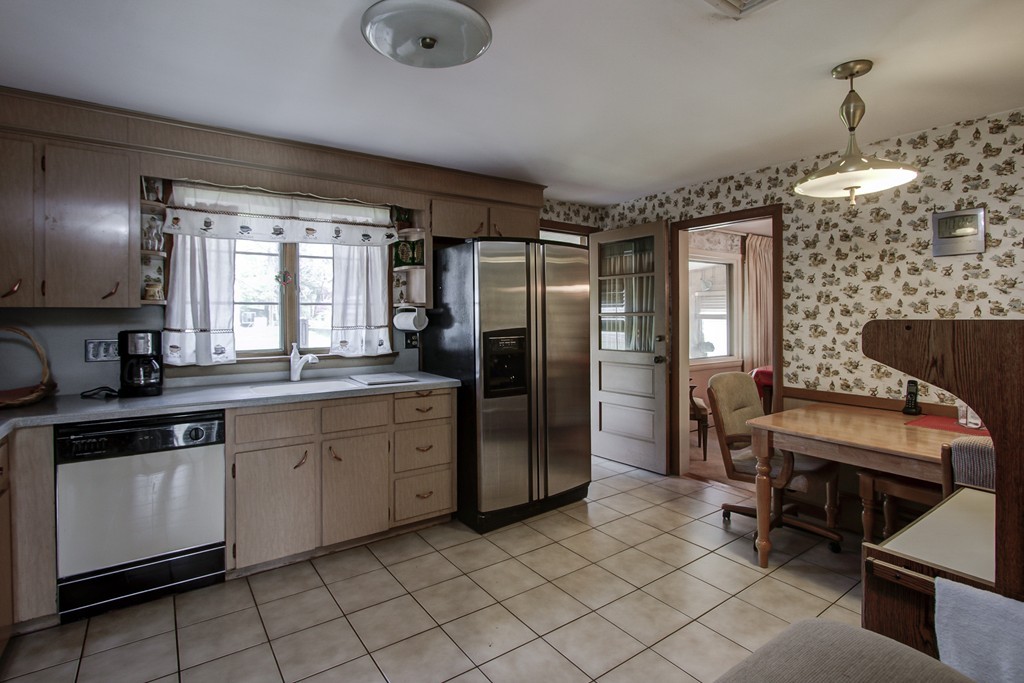 55 Tomahawk Road Arlington, MA 02474 - Photo 3 of 22 a kitchen with stainless steel appliances granite countertop a refrigerator and a stove top oven