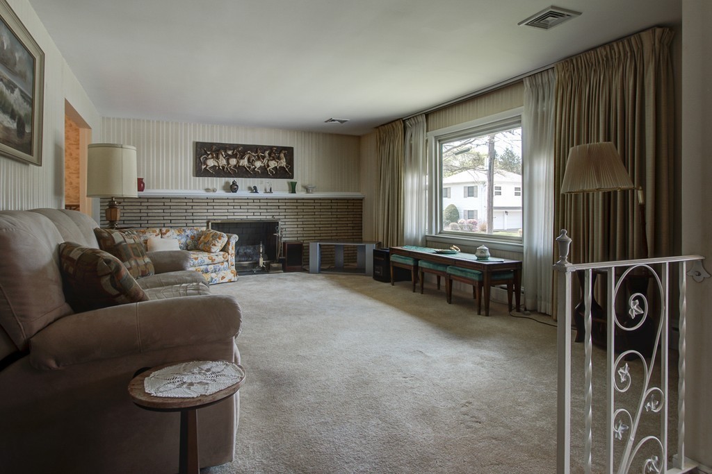 55 Tomahawk Road Arlington, MA 02474 - Photo 7 of 22 a living room with furniture and a fireplace