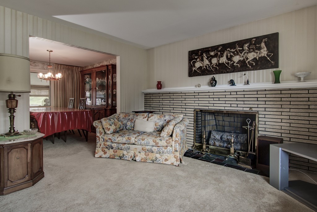 55 Tomahawk Road Arlington, MA 02474 - Photo 8 of 22 a living room with furniture and a fireplace