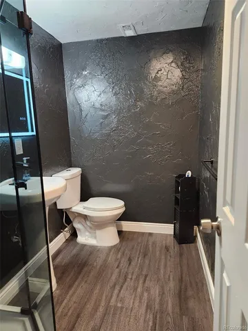 a bathroom with a toilet and a shower