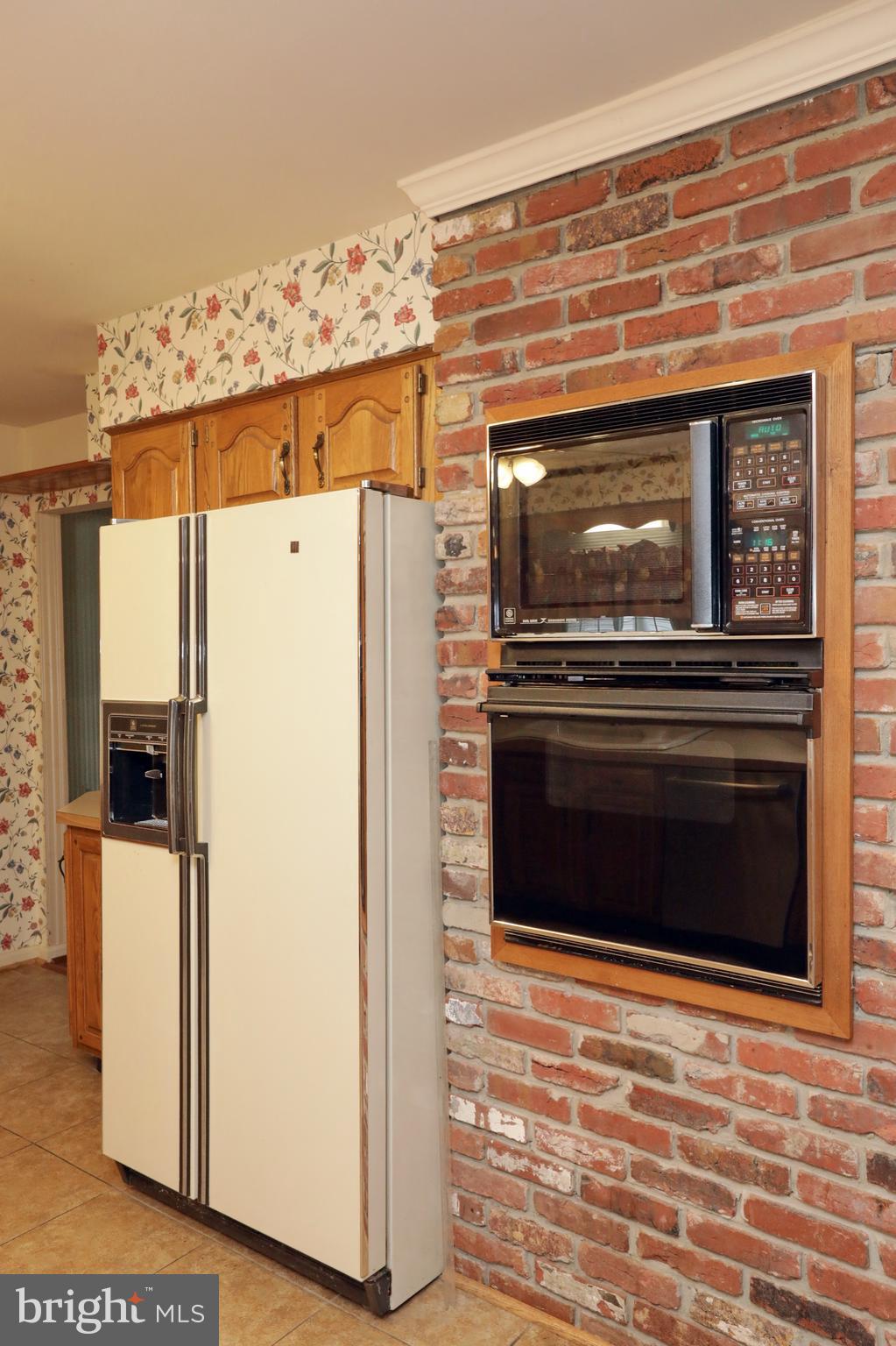 9154 Preference Drive La Plata, MD 20646 - Photo 21 of 65 Built-in oven/microwave w/brick wall in kitchen