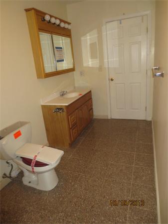 35 Houghton Street Worcester, MA 01604 - Photo 13 of 22 a bathroom with a toilet a sink and mirror