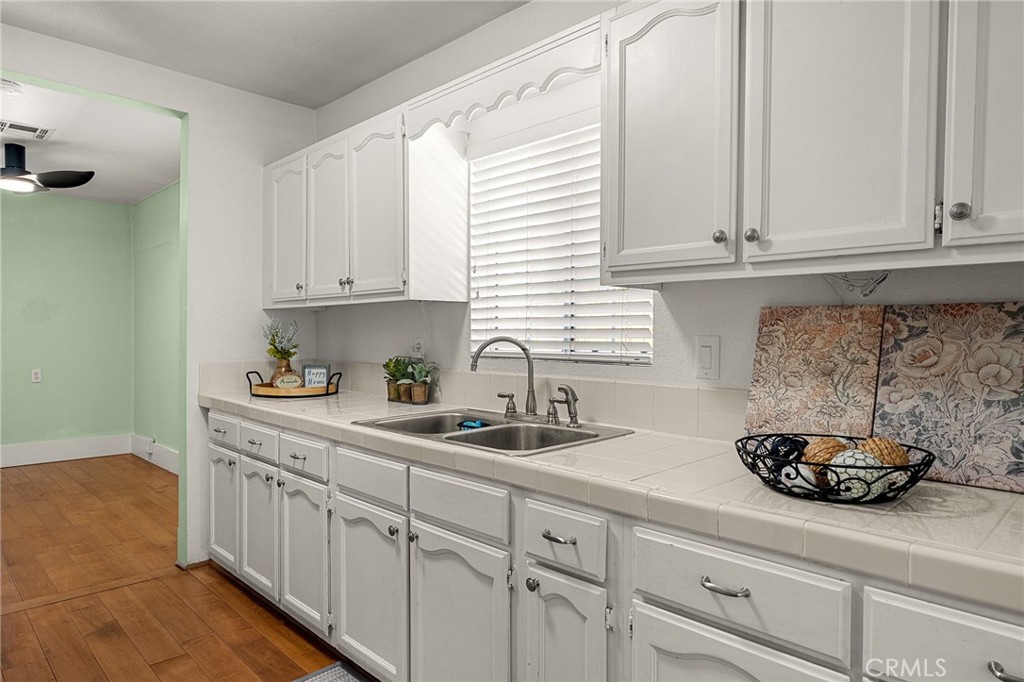 4390 Edgewood Place Riverside, CA 92506 - Photo 11 of 32 a kitchen with stainless steel appliances granite countertop white cabinets a sink and dishwasher