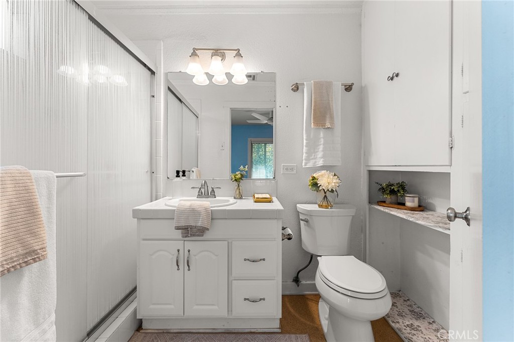 4390 Edgewood Place Riverside, CA 92506 - Photo 18 of 32 a bathroom with a sink toilet and shower