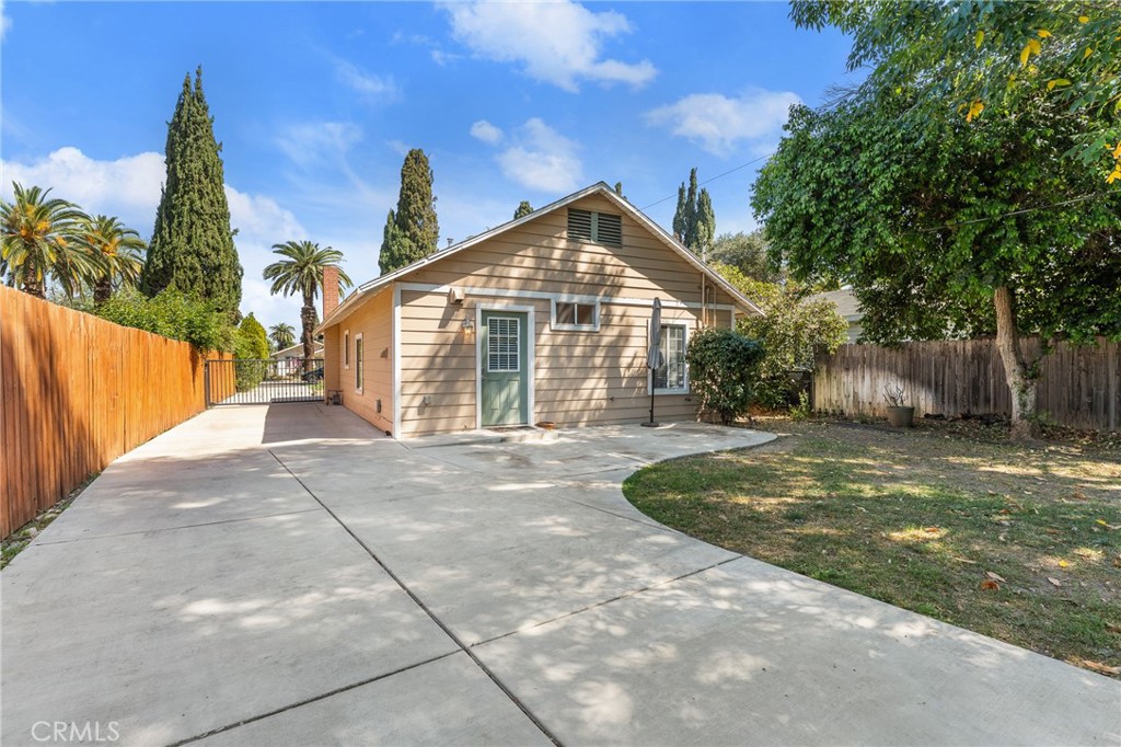 4390 Edgewood Place Riverside, CA 92506 - Photo 20 of 32 a view of a house with backyard and a tree