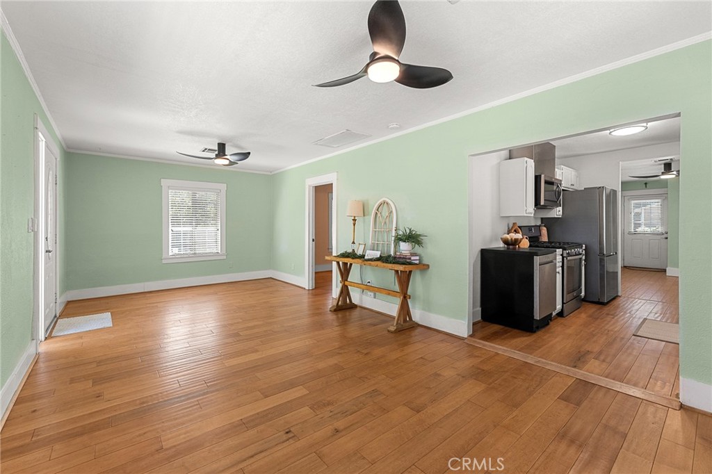 4390 Edgewood Place Riverside, CA 92506 - Photo 7 of 32 a view of a livingroom with wooden floor and a ceiling fan