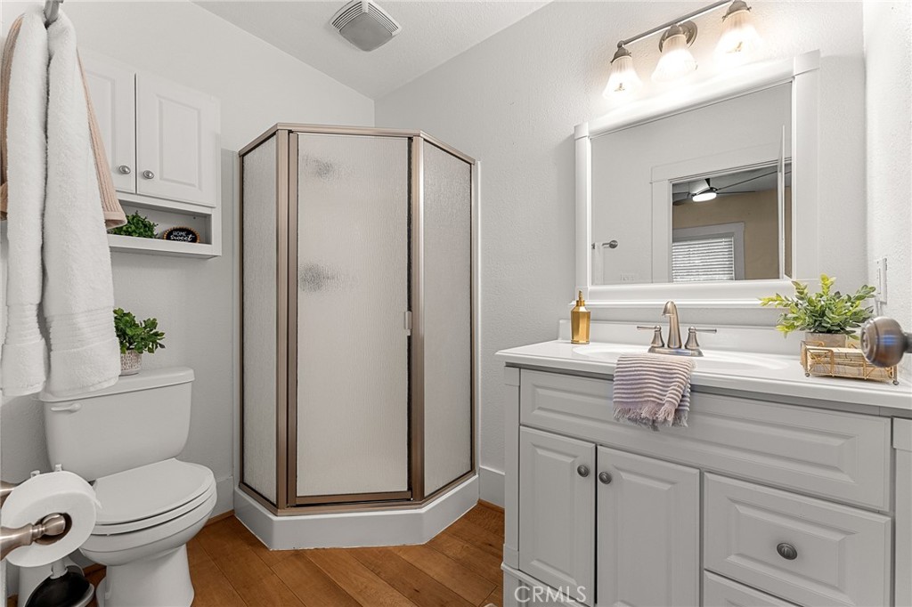 4390 Edgewood Place Riverside, CA 92506 - Photo 9 of 32 a bathroom with a granite countertop sink toilet and shower