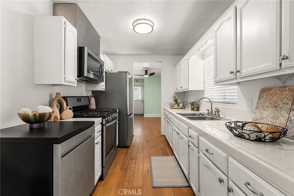 4390 Edgewood Place Riverside, CA 92506 - Photo 10 of 32 a kitchen with stainless steel appliances a stove a sink and a refrigerator