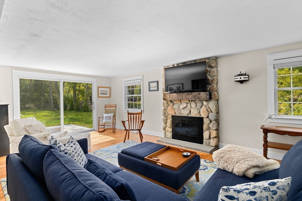 355 Tilden Road Scituate, MA 02066 - Photo 14 of 42 a living room with furniture a fireplace and a flat screen tv