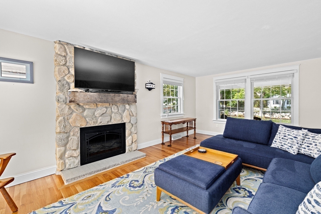355 Tilden Road Scituate, MA 02066 - Photo 16 of 42 a living room with furniture a flat screen tv and a fireplace