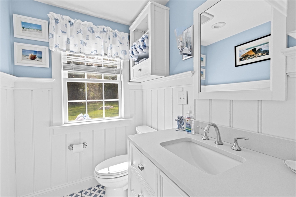 355 Tilden Road Scituate, MA 02066 - Photo 19 of 42 a bathroom with a sink a toilet and a large mirror