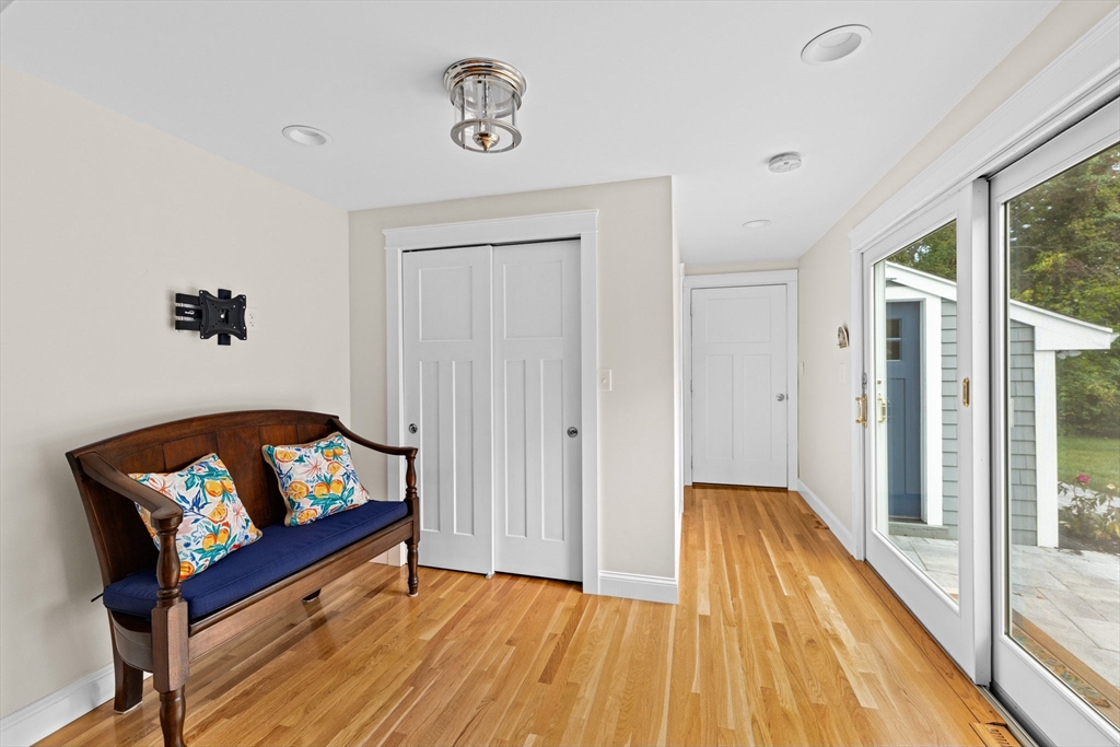 355 Tilden Road Scituate, MA 02066 - Photo 20 of 42 a view of a hallway with wooden floor and a workspace